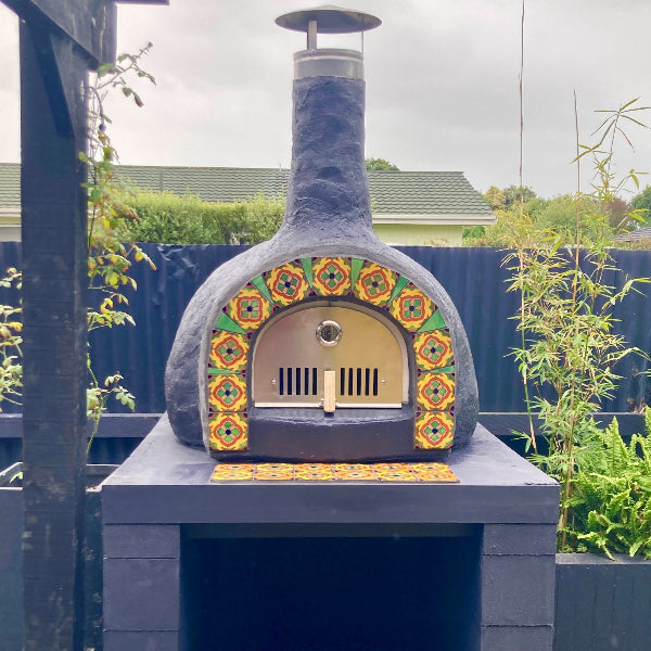 Outdoor pizza oven with decorative mosaic design 