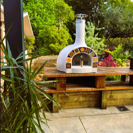 White outdoor pizza oven with decorative Mexican tiles
