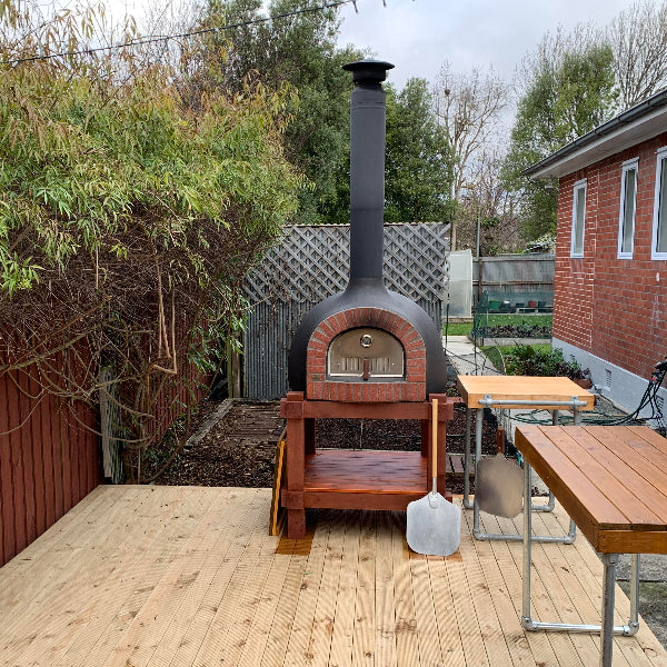 Outdoor pizza oven on a wooden deck
