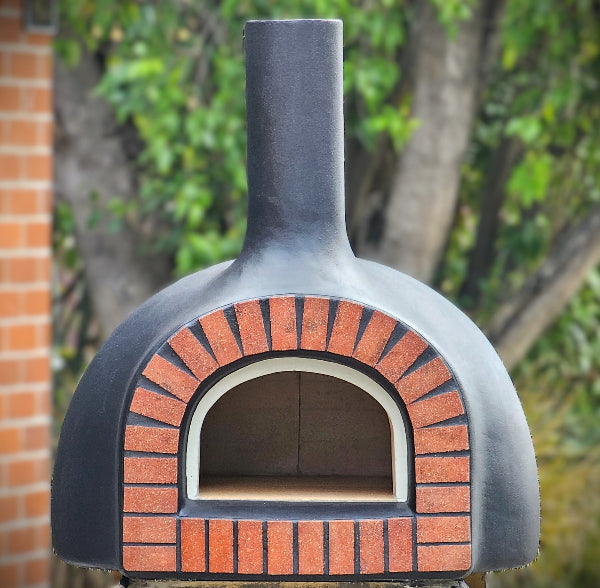 Outdoor brick oven with a brick arch