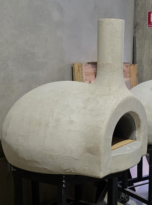 Wood-fired pizza oven with the precast outer shell assembled before final finishing.
